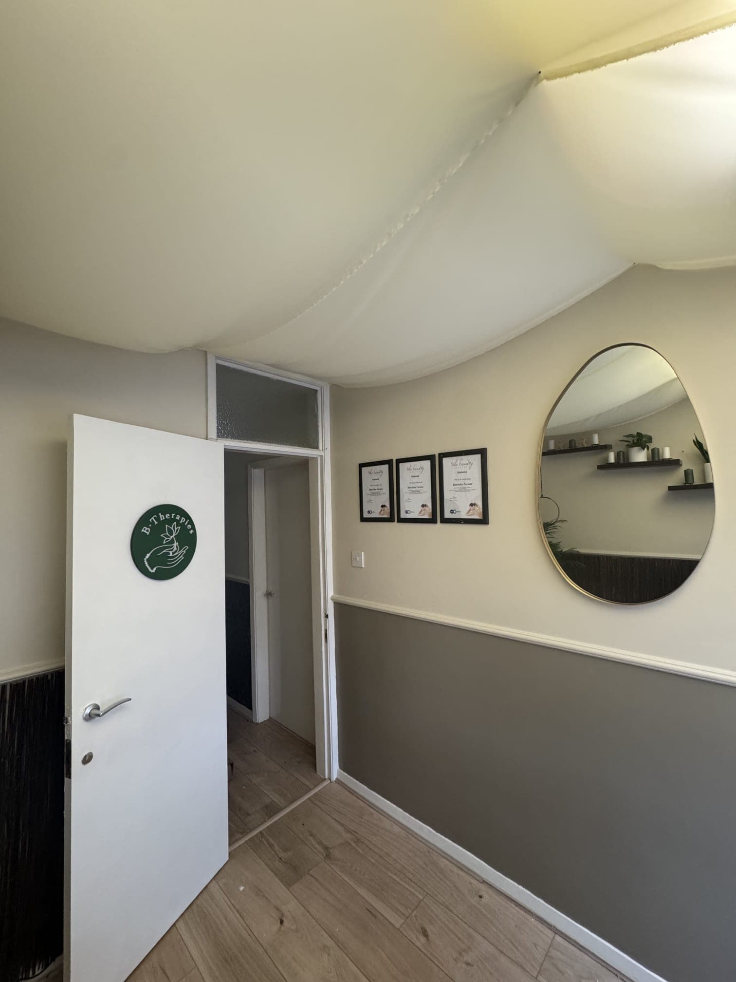 B Therapies treatment room entrance with branding and qualifications